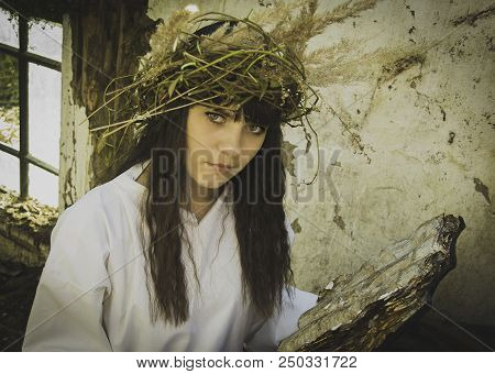Girl Druid Healer With A Wreath Of Wild Flowers On His Head Holding A Bunch Of Herbs In His Hands An