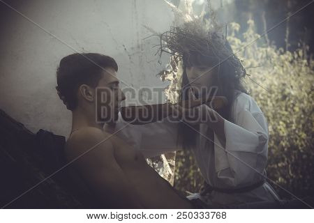 Girl Druid Healer With A Wreath Of Wild Flowers On His Head Holding A Bunch Of Herbs In His Hands An