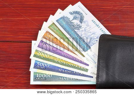 Malagasy Ariary In The Black Wallet  On A Wooden Background