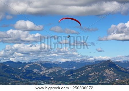 Paraglider Flying His Wing In The French Alps
