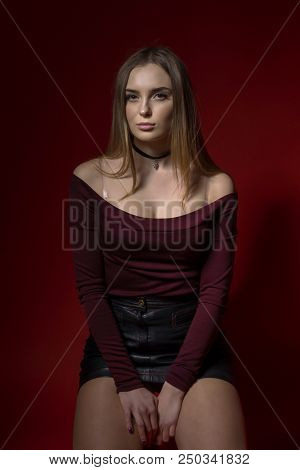 Portrait Of Sexy Woman In Studio Of Red Backgraund