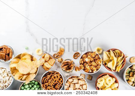 Variation Different Unhealthy Snacks Crackers, Sweet Salted Popcorn, Tortillas, Nuts, Straws, Bretse