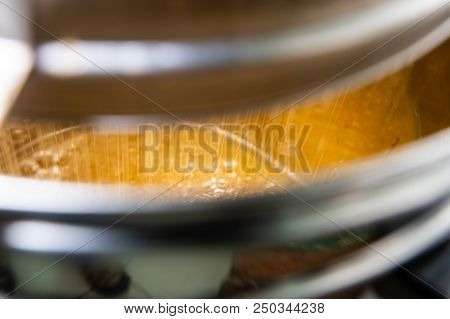 Strain The Poured Honey Through A Sieve. How To Harvest Honey. Filtering Raw Honey.