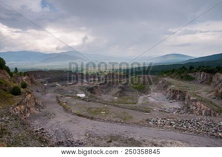Abandoned Stone Pit, Quarry In Transylvania , Romania On Cloudy , Rainy Day.