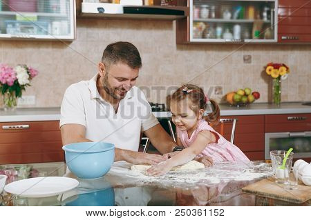 Little Kid Girl Help Man To Cook Christmas Ginger Cookies Preparing Dough At Table. Happy Family Dad