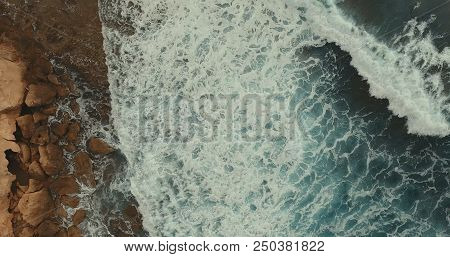 Aerial Photography. Sea Landscape And Blue Raging Waves. Rocky Coast.