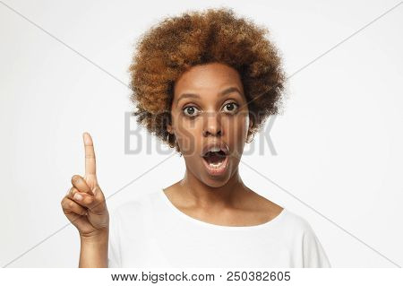 I Have An Idea! Attractive Afrcian American Woman Keeping Finger Pointed Upwards, Showing Something 