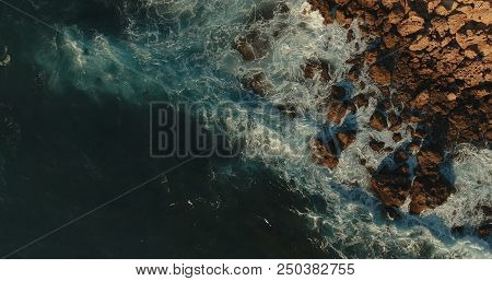 Aerial Photography. View From Above. Rocky Coast.waves Break Against Stones.