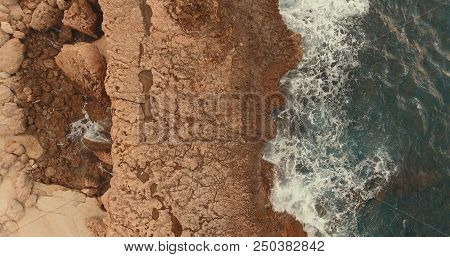 Aerial Photography. Sea Waves Around The Stones. View From Above. Foam Waves. One Wave Rolls On The 