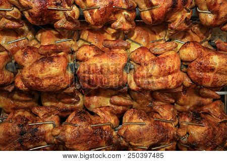 Chickens Roasting In Rotisserie In Germany. Europe