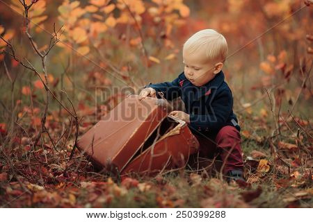 Adorable Boy On A Railway Station, Waiting For The Train With Suitcase