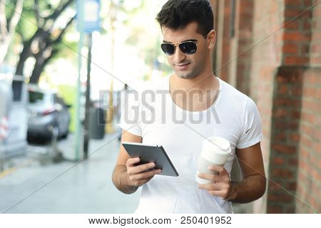 Man Using A Tablet.