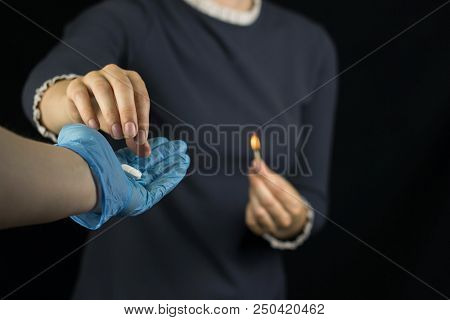 A Girl On A Black Background Holds A Burning Match, Pain And Burning Sensation In The Stomach, A Man