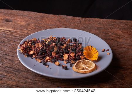 Dry Fruit Tea Flower And Lemon On Plate. Nice Red Wood Table