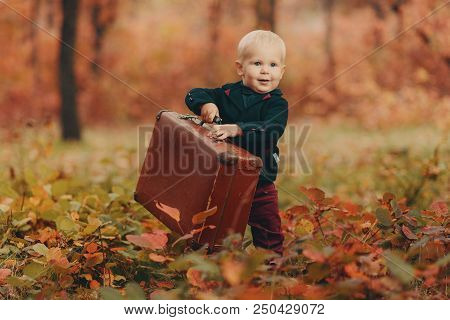 Adorable Boy On A Railway Station, Waiting For The Train With Suitcase