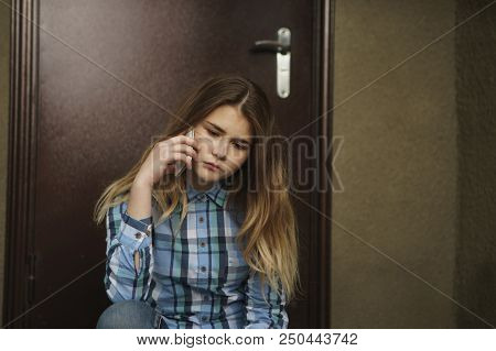 Single Sad Teen Holding A Mobile Phone Lamenting Sitting