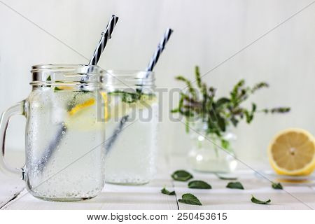 A Cooling Lemon Drink In A Glass Cup On A Wooden Table