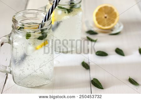 A Cooling Lemon Drink In A Glass Cup On A Wooden Table