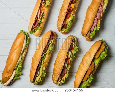 Fresh Sub Sandwich On White And Wheat Hoagies.