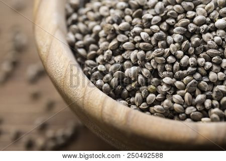 Cannabis Seeds In A Plate, On A Wooden Background, Space For Text