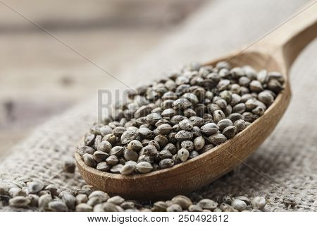 Hemp Seeds In A Rustic Wooden Spoon On The Burlap Napkin, Space For Text