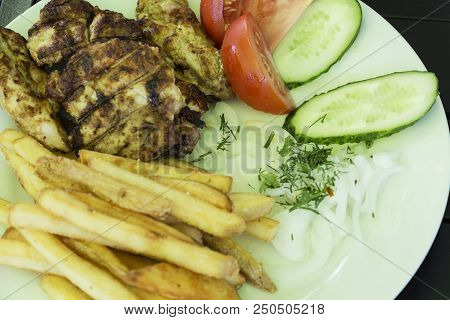 Salad Of Vegetables, Grilled Meat On A White Plate On A Black Background, Photo Menu