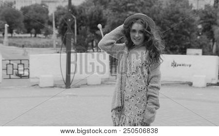 A Beautiful Girl In A Hat, Keeps The Hair From The Wind. Sits On Scraps. Walk Around The City. Portr