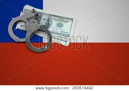 Chile Flag  With Handcuffs And A Bundle Of Dollars. The Concept Of Breaking The Law And Thieves Crim