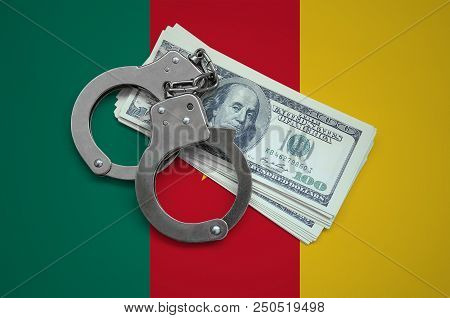 Cameroon Flag  With Handcuffs And A Bundle Of Dollars. Currency Corruption In The Country. Financial