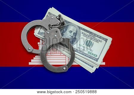 Cambodia Flag  With Handcuffs And A Bundle Of Dollars. Currency Corruption In The Country. Financial