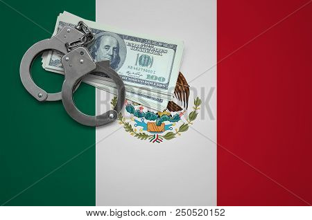 Mexico Flag  With Handcuffs And A Bundle Of Dollars. The Concept Of Breaking The Law And Thieves Cri