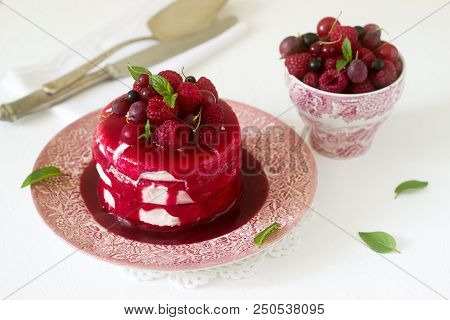 Ice Cream Cake With Berry Topping, Fresh Berries And Mint On A Light Background. Selective Focus.