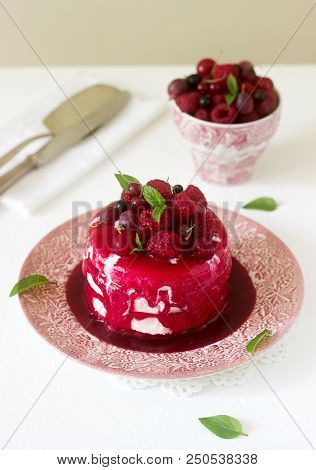 Ice Cream Cake With Berry Topping, Fresh Berries And Mint On A Light Background. Selective Focus.