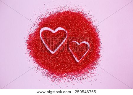 Two Hearts Drawn By Hand On Red Sugar On Pink Background. Wishes For Valentine's Day. Wedding Card