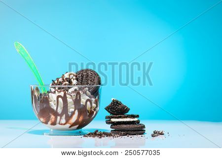 Delicious Vanilla Sundae With Chocolate And Chocolate Cookies In Plastic Cup With Plastic Spoon On A