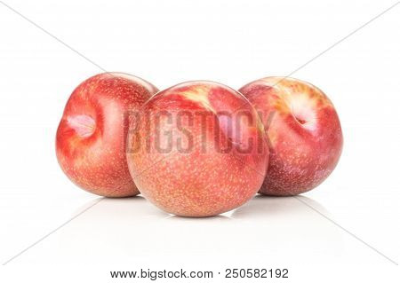 Group Of Three Whole Fresh Pluot Interspecific Plums Variety Stack Isolated On White