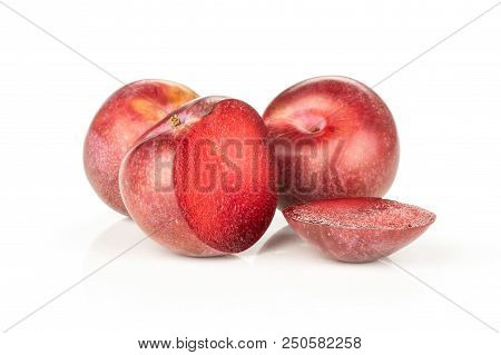 Group Of Two Whole Two Halves Of Fresh Pluot Interspecific Plums Variety One Sliced Isolated On Whit