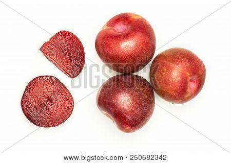 Group Of Three Whole One Half One Slice Of Fresh Pluot Interspecific Plums Variety Flatlay Isolated 
