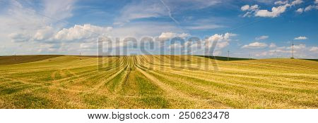 Harvested Empty Field On The Hills At Sunset.panorama Picture.