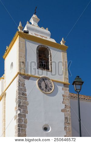 Tower Of Igreja Matriz De Alvor - Church In A Portuguese City. White Facade With Yellow Details. Bel