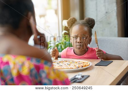 Capricious Little Girl With Fancy Hairstyle Can't Wait For Eating Pizza.