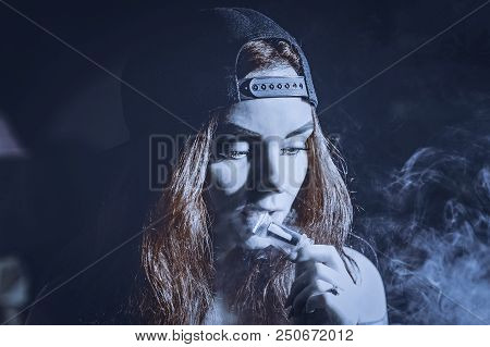 Red-haired Sexy Girl In A Cafe Dressed In Swimsuit Smoking A Hookah. Toned Image. Concept Of Pleasan