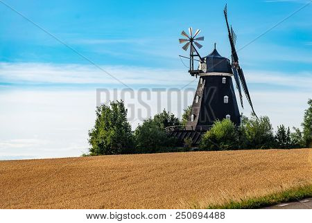 Wheat Windmill. Harvest Concent. The Stock Photo.