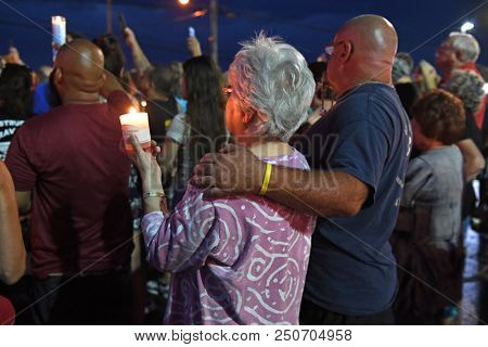 Branson, MO, USA â July 20, 2018: Mourners gather on the parking lot of Ride the Ducks for a candlelight vigil to remember the victims of the boat accident.