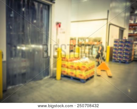 Worker With Manual Forklift Stockpile Goods Near Cold Storage Room In Wholesale Store