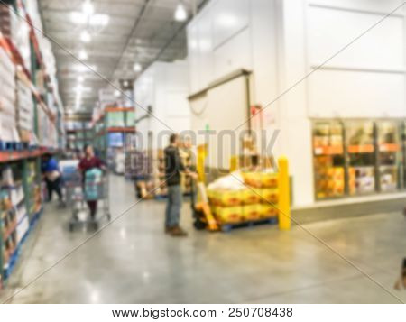 Worker With Manual Forklift Stockpile Goods Near Cold Storage Room In Wholesale Store
