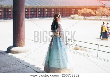Young Asian Woman Traveler In Korean National Dress Or Hanbok Walking Traveling Into The Gyeongbokgu