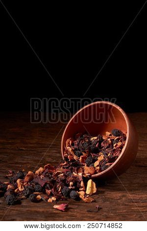 Raspberry Tea In Brown Clay Bowl. Wooden Background.