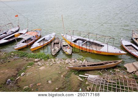VARANASI, UTTAR PRADESH, INDIA - JULY 7 2018: Wooden boats moored on the banks Ganges River, the holiest river in India, Varanasi