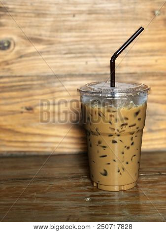 Ice Coffee In Plastic Cup And Brown Tube On The Wooden Table, Relaxing And Freshy, Vintage Style And